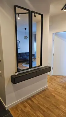 a mirror on a wall in a living room at Brooklyn88 Apartment in Niš