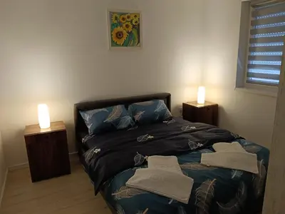 a bedroom with a bed with two candles on it at Apartman Petrovic 3 in Soko Banja