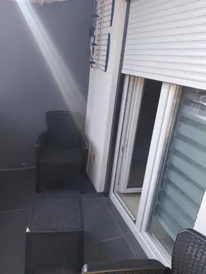 a balcony with a chair and a window at Apartman Petrovic 3 in Soko Banja