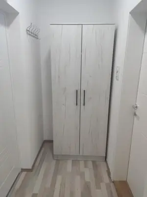 a white closet with a door in a room at Apartman Kaoma in Soko Banja