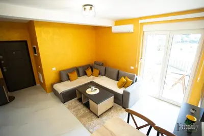 a living room with a couch and a table at FAMILY APARTMENTs 3 in Vrnjačka Banja