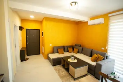 a living room with a couch and a table at FAMILY APARTMENTs 3 in Vrnjačka Banja