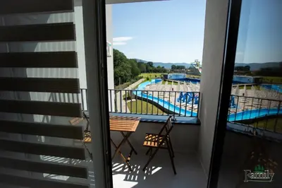 a balcony with a view of a swimming pool at FAMILY APARTMENTs 3 in Vrnjačka Banja