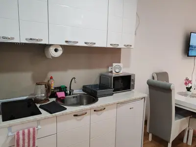 a kitchen with a sink and a microwave at Apartmani Lucky Place in Vrnjačka Banja