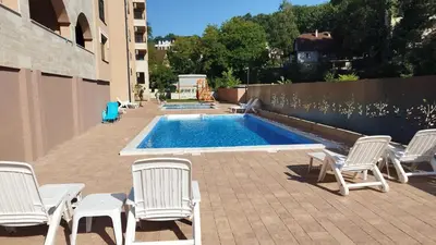 a group of chairs and a swimming pool at Apartmani Lucky Place in Vrnjačka Banja