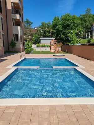 a swimming pool with a playground in a building at Apartmani Lucky Place in Vrnjačka Banja