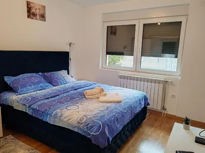a bedroom with a bed with two towels on it at Apartmani Lucky Place in Vrnjačka Banja