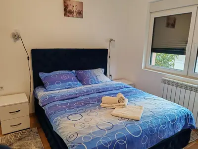 a bedroom with a bed with two towels on it at Apartmani Lucky Place in Vrnjačka Banja