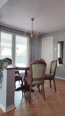 a dining room with a table and chairs at Mila LOFT city center-free parking in Vranje