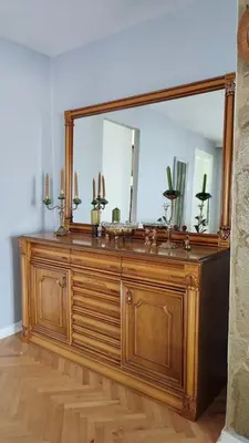 a large mirror on top of a wooden dresser at Mila LOFT city center-free parking in Vranje