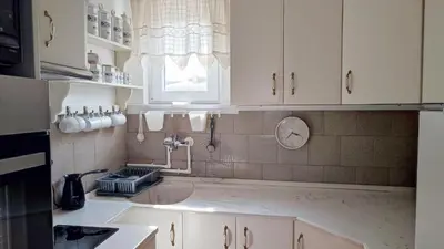 a kitchen with a sink and a window at Mila LOFT city center-free parking in Vranje