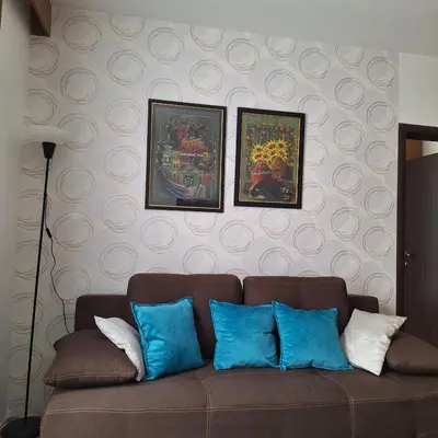 a brown couch with blue pillows in a living room at Kraljevski kutak Kraljevi čardaci in Kopaonik