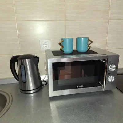 two blue cups sitting on top of a microwave at Kraljevski kutak Kraljevi čardaci in Kopaonik