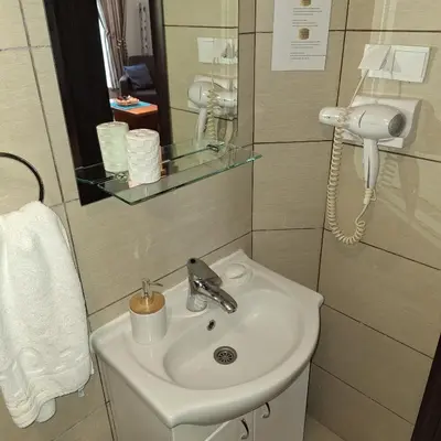 a bathroom with a sink and a phone at Kraljevski kutak Kraljevi čardaci in Kopaonik