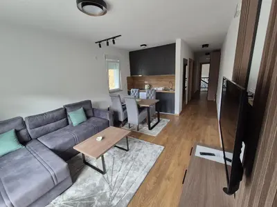 a living room with a couch and a table at Apartmani Banjski Biser in Jošanička Banja