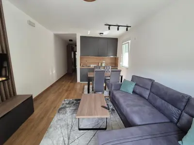 a living room with a couch and a table at Apartmani Banjski Biser in Jošanička Banja