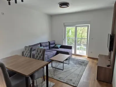 a living room with a couch and a table at Apartmani Banjski Biser in Jošanička Banja