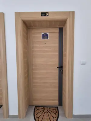 a wooden door with a sign on top of it at Apartmani Banjski Biser in Jošanička Banja