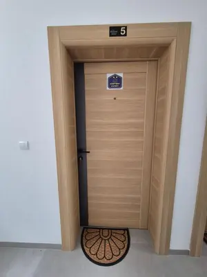 a wooden elevator door with a sign on it at Apartmani Banjski Biser in Jošanička Banja