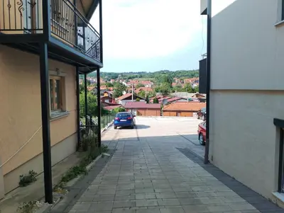 an alley with a car parked in a parking lot at Apartman Petrovic 4 in Soko Banja