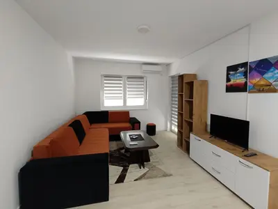 a living room with a couch and a table at Apartman Petrovic 4 in Soko Banja
