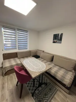 a living room with a couch and a table at Apartman city in Niš