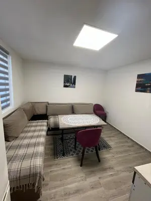 a living room with a couch and a table at Apartman city in Niš