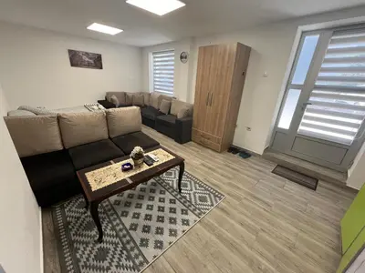 a living room with a couch and a table at Apartman city in Niš