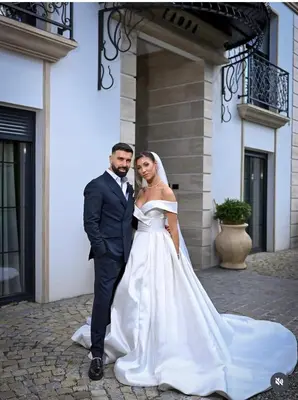 a bride and groom posing in front of a building at Vila Safra in Vrnjačka Banja