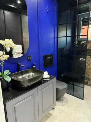 a blue bathroom with a sink and a toilet at Vila Safra in Vrnjačka Banja