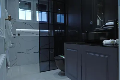 a black bathroom with a sink and a toilet at Vila Safra in Vrnjačka Banja