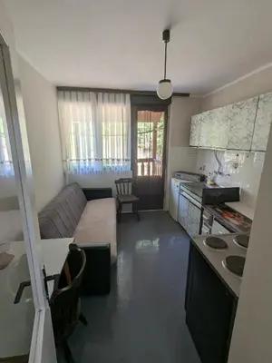a kitchen and a living room with a couch at Gordana in Senjski Rudnik