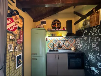 a kitchen with a green refrigerator in a room at Trnova Ruzica in Trnovac