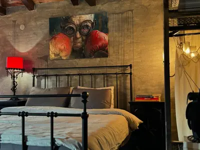 a bedroom with a bed with a painting on the wall at Trnova Ruzica in Trnovac