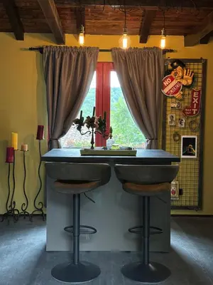 a bar with two stools in front of a window at Trnova Ruzica in Trnovac