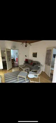 a living room with a couch and a table and chairs at Rustik in Soko Banja