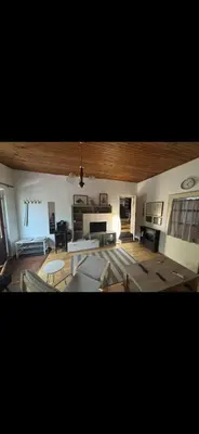 a living room with a table and a fireplace at Rustik in Soko Banja