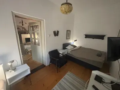 a bedroom with a bed and a desk and a mirror at Rustik in Soko Banja