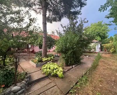 a garden with a bunch of bananas on a sidewalk at Rustik in Soko Banja