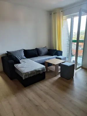 a living room with a blue couch and a table at Milijic Lux 2 in Soko Banja