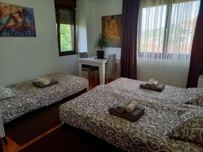 a hotel room with two beds with towels on them at Apartman KEJ 64m2 in Surdulica