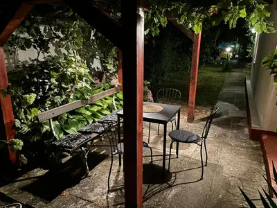 a patio with a table and chairs next to a garden at Rustik 2 in Soko Banja