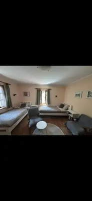 a living room with two beds and a couch at Rustik 2 in Soko Banja