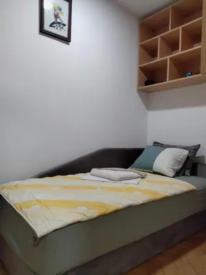 a bed in the corner of a room at Apartment studio Ignjatovic in Niš