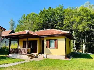 a small yellow house with a red roof at Vila Krunica in Šerdanova Mahala