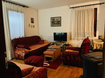 a living room with couches and a flat screen tv at Vila Krunica in Šerdanova Mahala