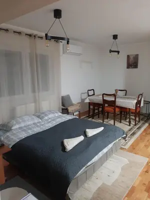 a bedroom with a large bed with two pillows on it at Slatki Snovi - Novi apartman u centru Vranja in Vranje
