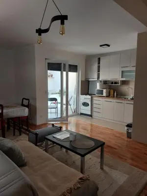 a living room with a couch and a table at Slatki Snovi - Novi apartman u centru Vranja in Vranje