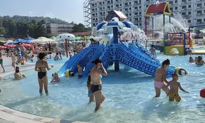 a group of people in the water at a water park at Metropolitan Royal in Jagodina