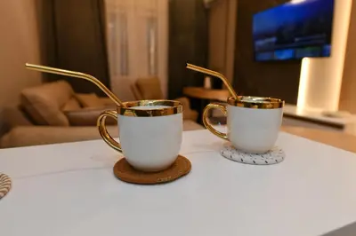 two coffee cups sitting on top of a table at Metropolitan Royal in Jagodina
